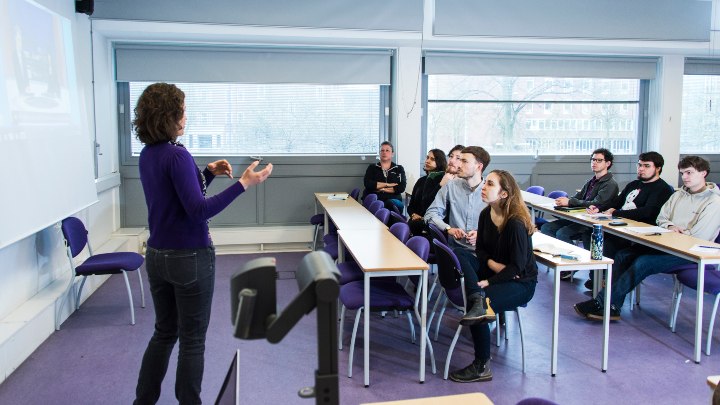 Social Anthropology students in a classroom, looking at a teacher.