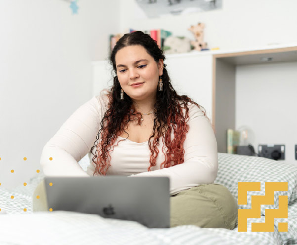 A student looking at their laptop.