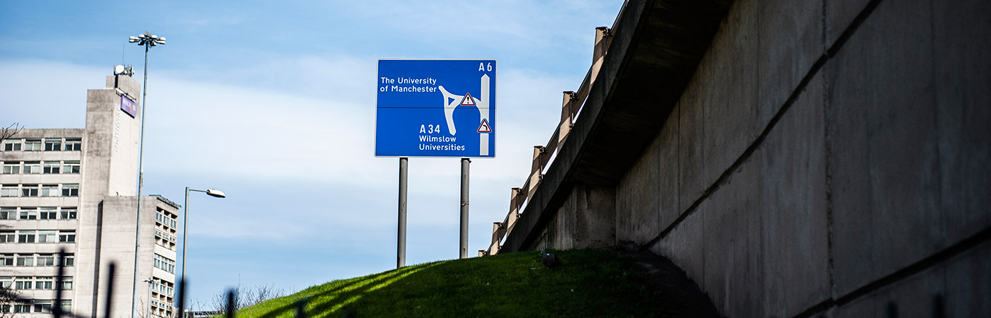 Signage showing travel routes to the uni